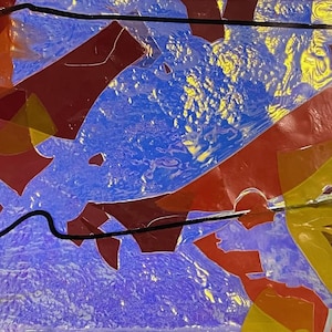 May include: Abstract artwork with a vibrant mix of colors. The image features overlapping shapes in shades of red, yellow, and orange against a blue and yellow background. A black line curves across the composition, adding a contrasting element.