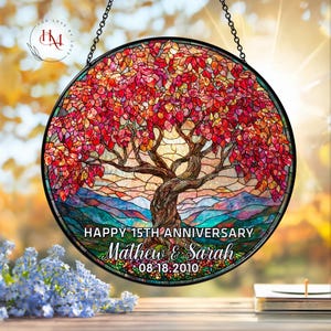 May include: A round stained glass window with a tree design. The tree has red and orange leaves, with a brown trunk and branches. The text "HAPPY 15TH ANNIVERSARY Mathew & Sarah 08.18.2010" is at the bottom.