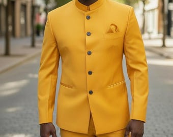 May include: A mustard yellow suit with a mandarin collar, featuring a matching pocket square and dark buttons. The suit includes a tailored jacket and matching trousers, creating a cohesive and stylish ensemble. The outfit is suitable for formal events.