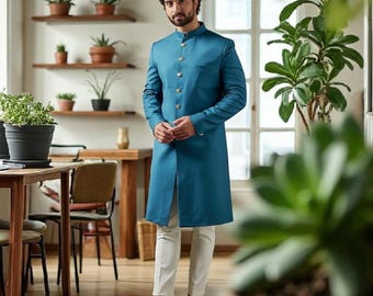 May include: A teal long coat with gold buttons, paired with white pants and brown shoes. The coat has a mandarin collar and a front slit. The image also shows the text "KING MEN'S TAILOR".