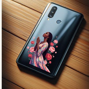 May include: Black smartphone case featuring an illustration of a woman with her hands clasped in prayer, surrounded by pink roses. The woman is wearing a colorful dress. The phone case is on a wooden surface.