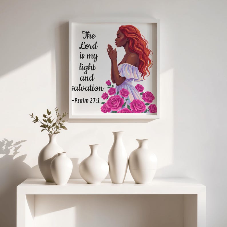 May include: A framed print featuring a woman with red hair, praying, surrounded by pink roses. The text reads "The Lord is my light and salvation -Psalm 27:1." Below, a white shelf displays five white ceramic vases, some with plants.