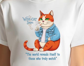 May include: White t-shirt featuring a cartoon cat with orange and white fur, wearing a blue denim jacket. The cat is holding a cigarette and the text "WISE-CAT Says:" and "The world reveals itself to those who truly watch" are displayed.