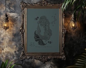 May include: An ornate gold framed art print. The print features a black and white illustration of a mermaid with long hair and a striped tail. The background is teal. The text at the bottom reads "Perhaps, just a bit of mermaid."