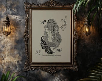 May include: An art print in a gold ornate frame, depicting a black and white illustration of a mermaid. The image shows the mermaid's back, long hair, and a striped tail, with bubbles and fish. Text is at the bottom.
