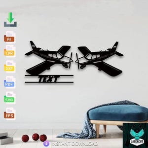 May include: Black metal wall art featuring two airplane silhouettes facing each other. Below the planes is a horizontal bar with the word "TEXT" cut out. The design is suitable for home decor.