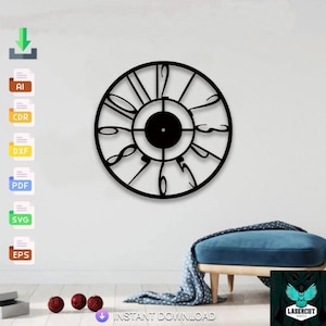 May include: A black, laser-cut wall clock with Roman numerals. The clock is circular with a minimalist design, featuring a central disc and stylized hands. The clock is mounted on a white wall, with a blue ottoman and decorative items in the background.