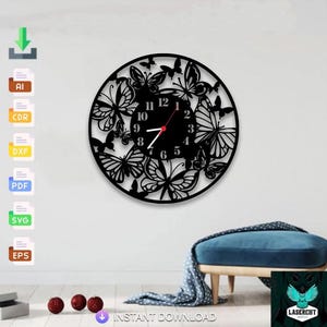 May include: Black, round wall clock featuring a butterfly design. The clock face has a black background with white numbers and red hands. The clock is surrounded by butterfly cutouts. The text "INSTANT DOWNLOAD" is visible.