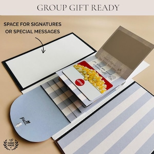 Handmade waterfall gift card holder book in gray and white stripes with pull tab, shown holding an AMC gift card. Features space inside for group signatures or personalized messages, making it a perfect handmade birthday card, coworker gift, grandmother keepsake, daughter surprise, or college survival kit. Unique DIY trend gift that turns gift cards into a memorable presentation.