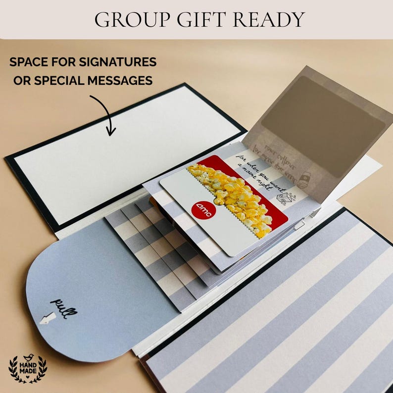 Handmade waterfall gift card holder book in gray and white stripes with pull tab, shown holding an AMC gift card. Features space inside for group signatures or personalized messages, making it a perfect handmade birthday card, coworker gift, grandmother keepsake, daughter surprise, or college survival kit. Unique DIY trend gift that turns gift cards into a memorable presentation.