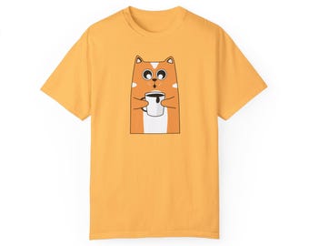 May include: A yellow t-shirt with a cartoon orange cat drinking from a white mug. The cat has black eyes and a black nose.