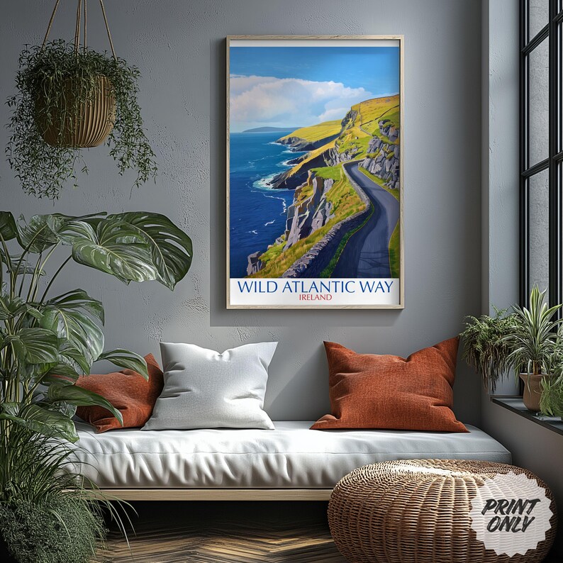 a framed poster of the Wild Atlantic Way in Ireland, hanging on a wall above a couch with pillows.