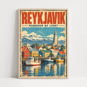May include: A vertical poster featuring the text REYKJAVIK HARBOUR OF LIGHT in bold red letters. The illustration depicts a harbour with colourful boats, a coastal town with red, yellow, and blue buildings, a tall church, and snow-capped mountains.