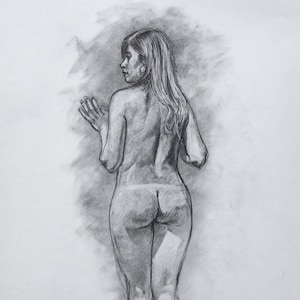 May include: A charcoal drawing of a nude woman standing with her back to the viewer. Her hair is long and flowing, and she is looking over her shoulder.