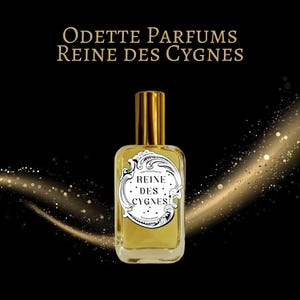 May include: A white ceramic mug with a black handle and the text "But First, Coffee" in a bold, black font. The mug is set against a blurred background, suggesting a cosy setting.