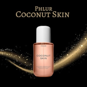 May include: A clear, rectangular perfume bottle with a white cap, labeled "PHLUR COCONUT SKIN." The bottle contains a light pink liquid. The text "HAIR & BODY FRAGRANCE MIST BRUME DE PARFUM POUR CHEVEUX ET CORPS" is printed below. The background is black with gold sparkles.