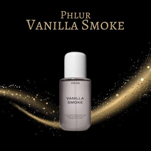 May include: A perfume bottle with a white cap and a clear body, labeled "Vanilla Smoke" by Phlur. The bottle is set against a black background with gold glitter accents. The product is a hair and body fragrance mist.