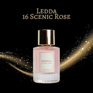 May include: A perfume bottle with a gold cap and a pink liquid inside. The bottle has a white label with the text "LEDDA 16 SCENIC ROSE". The background is black with gold glitter accents.