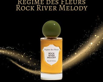 May include: A perfume bottle with the text "REGIME DES FLEURS ROCK RIVER MELODY" on a black background. The bottle has a green cap and a label that reads "Régime des Fleurs ROCK RIVER MELODY Eau de Parfum". Gold sparkles and a golden wave are in the background.