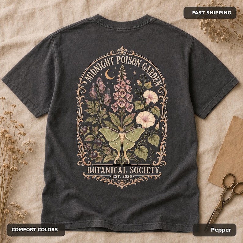 Pepper Comfort Colors T-shirt flatlay showing the large vintage poison garden and luna moth back design.