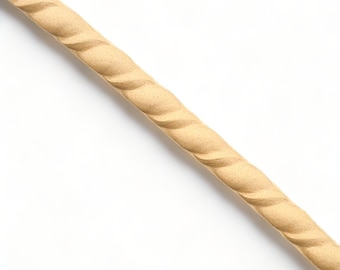 May include: A close-up of a beige rope molding, a decorative trim for furniture or home decor.
