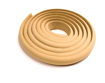 May include: A coiled roll of beige foam weather stripping. The foam is thick and has a slightly textured surface.