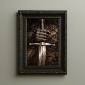 May include: Framed artwork featuring a close-up of a hand gripping a sword. The hand, clad in a dark, textured glove, firmly holds the sword's hilt. The sword's blade is silver, and the background shows armor. The frame is black.