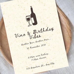 May include: A cream-colored invitation with a wine theme. The invitation features a wine bottle and glass illustration. Text includes "Vino & Birthday Vibes," date, time, and location details. The invitation is on a wooden plate.