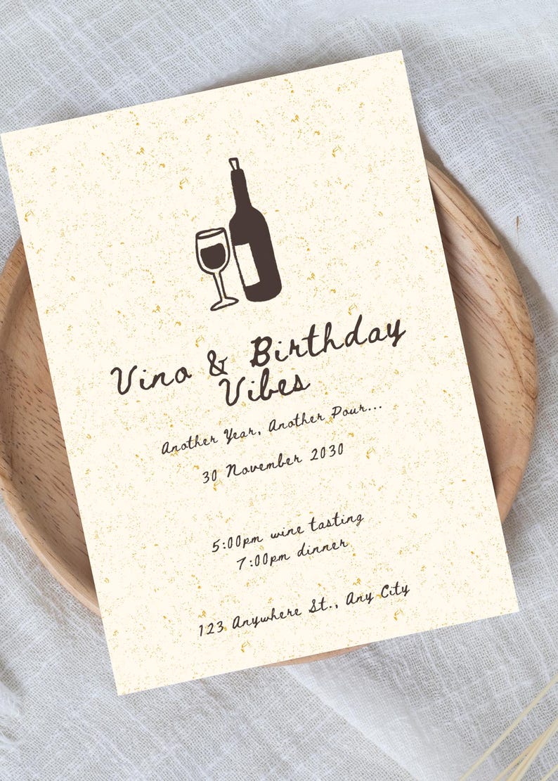 May include: A cream-colored invitation with a wine theme. The invitation features a wine bottle and glass illustration. Text includes "Vino & Birthday Vibes," date, time, and location details. The invitation is on a wooden plate.