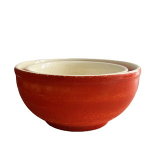 May include: A set of three ceramic vases in varying heights and shapes. The vases are glazed in a matte white finish, offering a minimalist aesthetic. The tallest vase is approximately 10 inches high.
