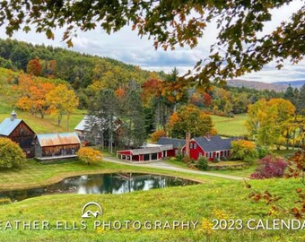 May include: A scenic view of a red farmhouse with a pond in the foreground. The farmhouse is surrounded by trees with fall foliage in shades of red, orange, and yellow. The image is taken from a hilltop, looking down at the farmhouse and pond. The text "HEATHER ELLS PHOTOGRAPHY 2023 CALENDAR" is at the bottom of the image.
