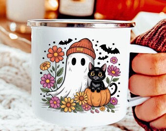 May include: White enamel mug with a Halloween-themed design. The illustration features a friendly ghost wearing an orange beanie, a black cat in a pumpkin, flowers, stars, and bats. The mug has a silver rim and a white handle.