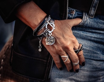 Double wrap bracelet with multiple snake chains, leather and unique buckle with coin pendant for a statement look