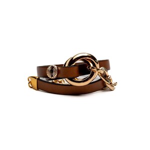 May include: Brown leather wrap bracelet with gold-tone metal accents. The bracelet features a large circular clasp, a decorative button, and a small chain detail. The leather is a rich brown color, and the metal has a polished finish.