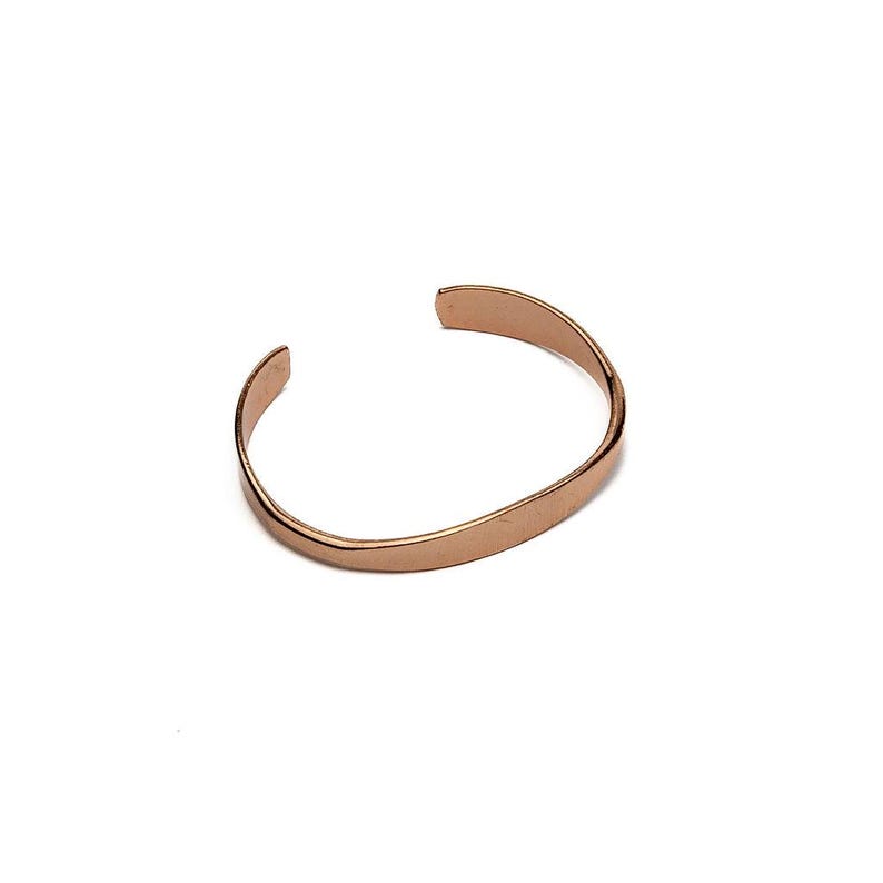 May include: A copper-colored cuff bracelet with a simple, open design. The bracelet has a smooth, polished surface and a slightly curved shape. The open ends allow for easy adjustment and wear. The jewelry is set against a white background.