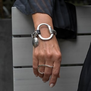 Standout black leather and horsebit metal made in the Uno de 50 style, equestrian cuff bracelet