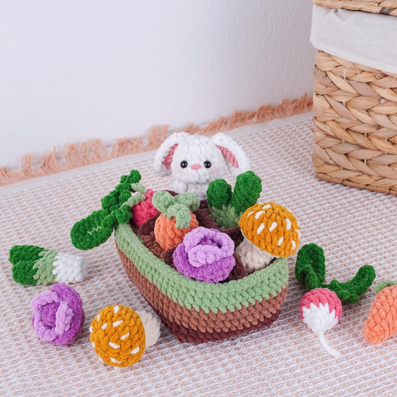 May include: A handmade crochet set featuring a white bunny in a brown, green, and beige basket filled with colorful crochet vegetables. The vegetables include carrots, radishes, and mushrooms. The set is designed for children.