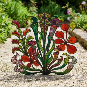 May include: A decorative metal garden stake featuring a vibrant, multi-colored illustration of various carnivorous plants, including Venus flytraps and pitcher plants in shades of red, green, yellow, and purple with intricate black outlines.