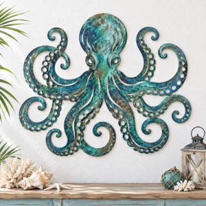 May include: A wall-mounted octopus sculpture crafted from metal with a weathered teal and copper patina finish. The octopus features eight curved, symmetrical tentacles with circular suction cup details and a central head with two eyes.