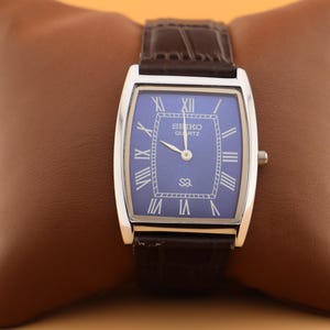 Built for modern lifestyles Seiko Slim Vintage Barrel Tank Quartz Men's Wrist Watch With Blue Dial and New Dark Brown Strap