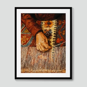 May include: A framed print of a painting depicting a hand working on a rug. The hand is light-skinned and the sleeve is a dark red. The rug has a colorful, intricate pattern with red, blue, and yellow hues. The fringe of the rug is visible.