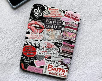 May include: A rectangular e-reader cover featuring a collage of stickers in black, white, and red. The design includes various text phrases like "Married with a harem of book boyfriends," "CAME FOR THE FANTASY STAYED FOR THE SMUT," and "Berry Book Club."