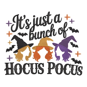 May include: A white graphic with the text "It's just a bunch of Hocus Pocus". The design features three witch silhouettes with orange, blonde, and purple hair, wearing black, tan, and purple witch hats. Bats and stars surround the text.