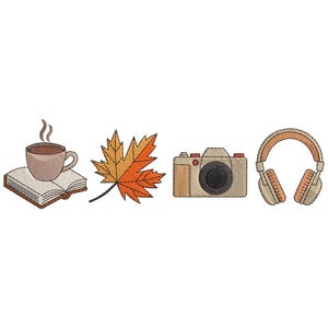 May include: An embroidered design featuring a steaming coffee cup on an open book, a fall leaf, a camera, and a pair of headphones. The color palette includes shades of brown, orange, and beige, evoking a cozy autumn theme.