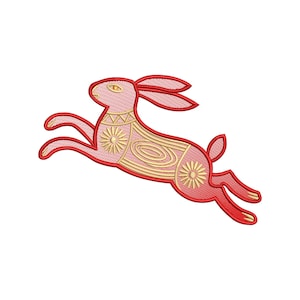 May include: A red and gold embroidered rabbit design in a leaping pose. The rabbit features intricate gold floral and geometric patterns on its body. The design is set against a white background, highlighting the vibrant colors and detailed stitching.