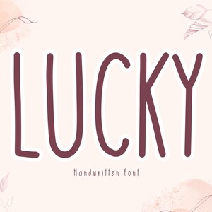 May include: The word "LUCKY" in a bold, handwritten font, in a deep burgundy color with a white outline, is centered on a light pink background. Below the word is the text "Handwritten font". Decorative floral elements and watercolor-style shapes frame the text.