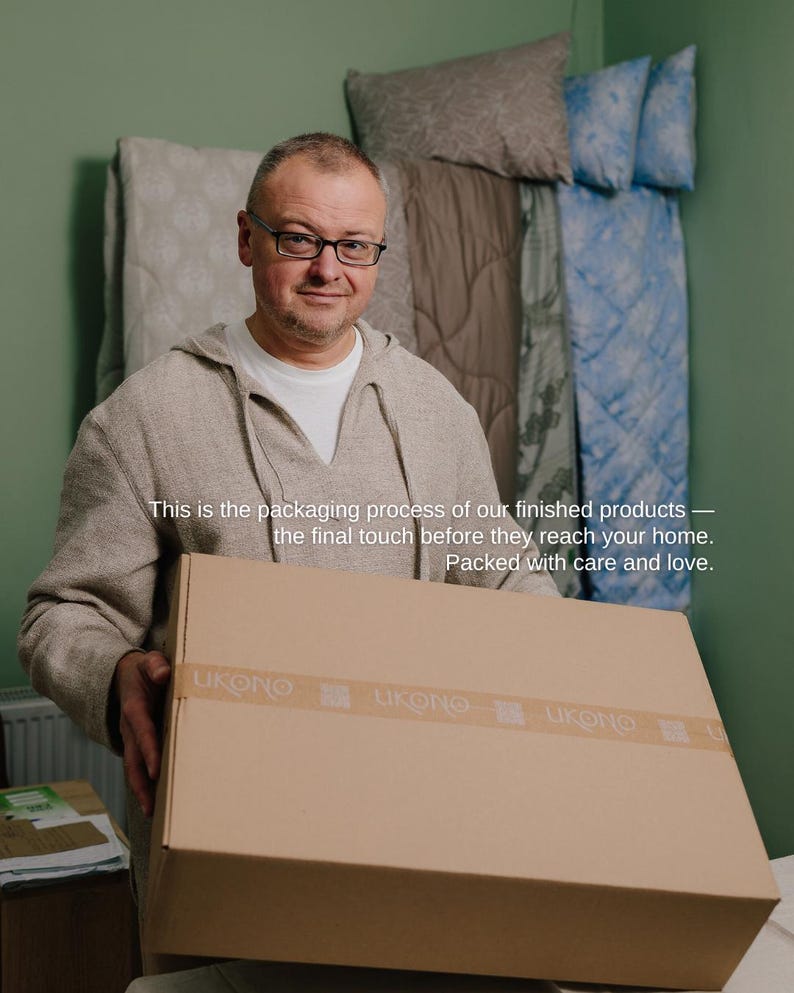 May include: A man wearing glasses holds a large cardboard box with the brand name "LUKONO" on the tape. The text on the image reads: "This is the packaging process of our finished products - the final touch before they reach your home. Packed with care and love."