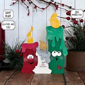 May include: Three wooden Christmas candle decorations with painted faces. The candles are red, green, and white with yellow flames. The green candle has dripping wax and a heart on the side. The text "SVG Digital File" is in the upper right corner of the image.