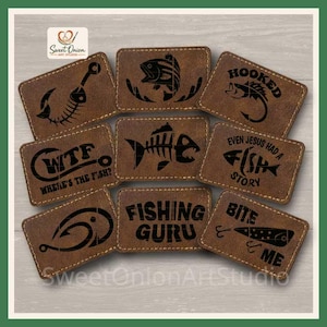 May include: A collection of eight rectangular brown leather patches with stitched edges, each featuring black laser-engraved fishing-themed designs and text including "WTF Where's the fish?", "Fishing Guru", "Even Jesus had a fish story", and "Bite me".