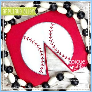 May include: Red fabric with a white baseball applique with red stitching. The applique is a partial circle with a slice missing. The fabric is surrounded by a garland of black and white beads.